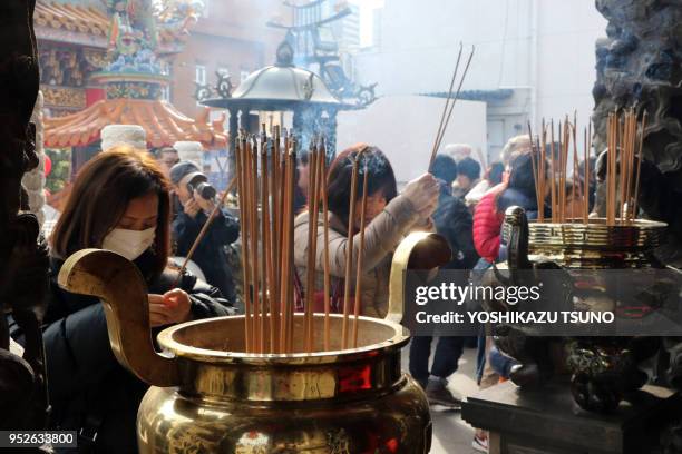 People visit a Chinese shrine at Yokohama Chinatown as Chinese Lunar New Year started in Yokohama, suburban Tokyo on January 29, 2017. People...