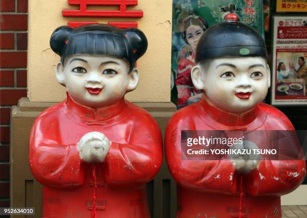 Chinese dolls stand in front of a Chinese restaurant at Yokohama Chinatown as Chinese Lunar New Year started in Yokohama, suburban Tokyo on January...