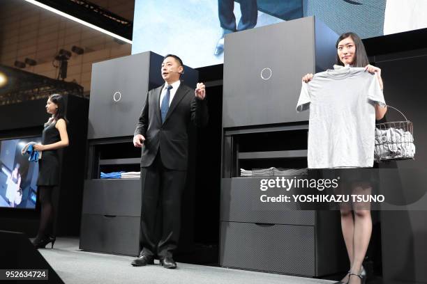 Japan's Seven Dreamers Laboratories president Shinichi Sakane introduces automatic laundry folding machine "Laundroid 1" which will go on sale next...