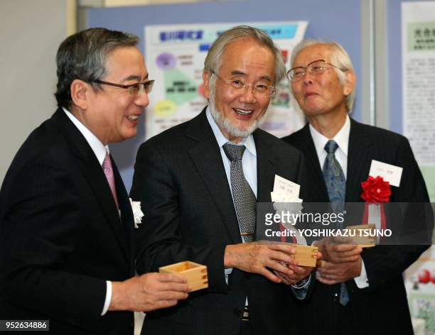 Tokyo Institute of Technology president Yoshinao Mishima toasts with professor Yoshinori Ohsumi and 2000 Nobel laureate Hideki Shirakawa who...