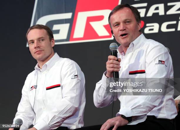 Japan's automobile giant Toyota Motor's world rally championship team leader Tommi Makinen speaks while driver Jari-Matti Latvala looks on as they...