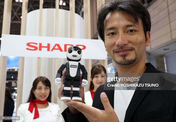 Japanese robot creator Tomotaka Takahashi displays a robot smartpone "RoBoHoN", started to sell this May from Sharp at the CEATEC Japan 2016 in...