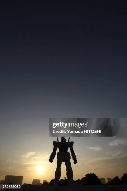 Gundam model is seen at a park in Tokyo, capital of Japan, June 12, 2009. The 18-meter-tall model is built to celebrate the 30th anniversary of the...