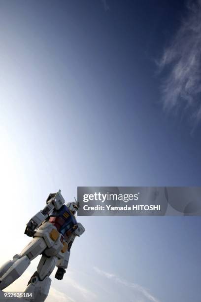 Gundam model is seen at a park in Tokyo, capital of Japan, June 12, 2009. The 18-meter-tall model is built to celebrate the 30th anniversary of the...