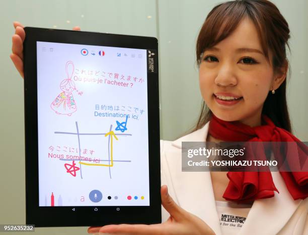 Model displays Mitsubishi Electric's user interface technology enabling users to display their spoken words on a tablet or smartphone by dragging...