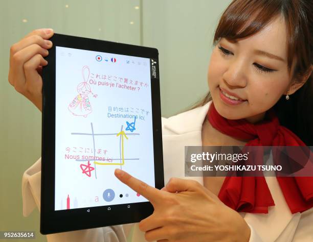 Model displays Mitsubishi Electric's user interface technology enabling users to display their spoken words on a tablet or smartphone by dragging...