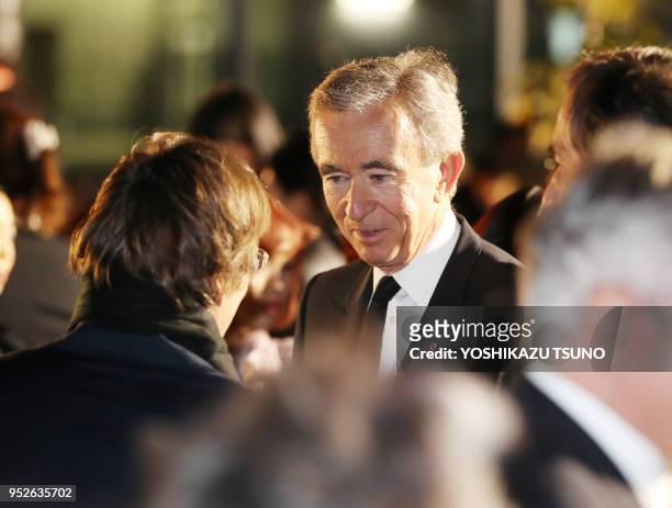 French fashion giant LVMH group CEO Bernard Arnault chats with Fendi CEO Pietro Beccari as they enjoy Dior's 2017 spring-summer haute couture...