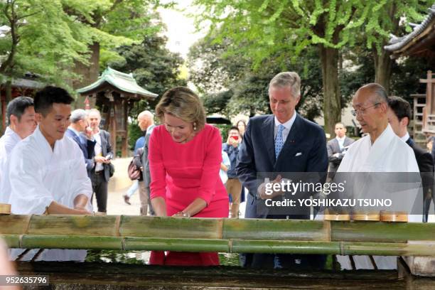 Belgian King Philippe and Queen Mathilde wash their hands as they visit the Nezu shrine in Tokyo on October 10, 2016. Belgian royal couple are now in...