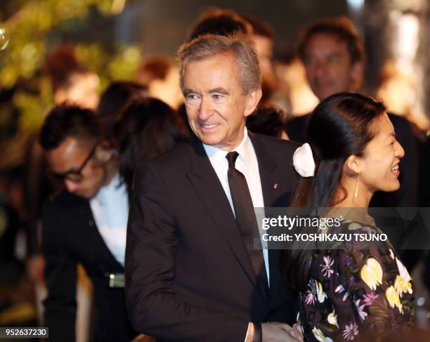 French fashion giant LVMH group CEO Bernard Arnault smiles as he enjoyed Dior's 2017 spring-summer haute couture collection at the rooftop of the...