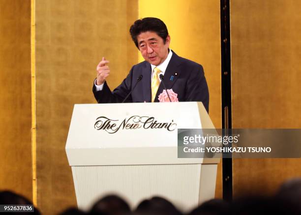 Japanese Prime Minister Shinzo Abe delivers a speech before business leaders at a Tokyo hotel on January 5, 2017. Three Japanese business groups held...
