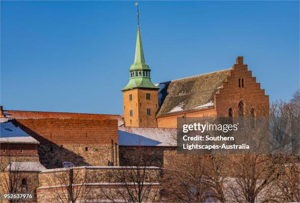 view to the akershus festning during mid-winter in oslo, norway. - akershus fortress stock-fotos und bilder