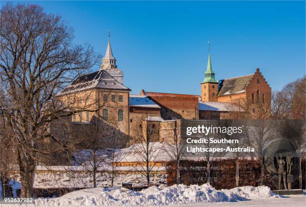 view to the akershus festning during mid-winter in oslo, norway. - ice fortress stock pictures, royalty-free photos & images