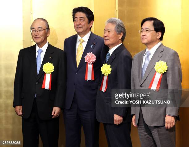 Japanese Prime Minister Shinzo Abe poses with Japanese business group leaders Akio Mimura , Sadayuki Sakakibara and Yoshimitsu Kobayashi for photo...