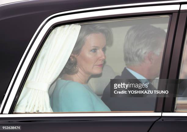 Belgian King Philippe and Queen Mathilde are in an Imperial limousine upon their arrival at the Tokyo International Airport on October 10, 2016....