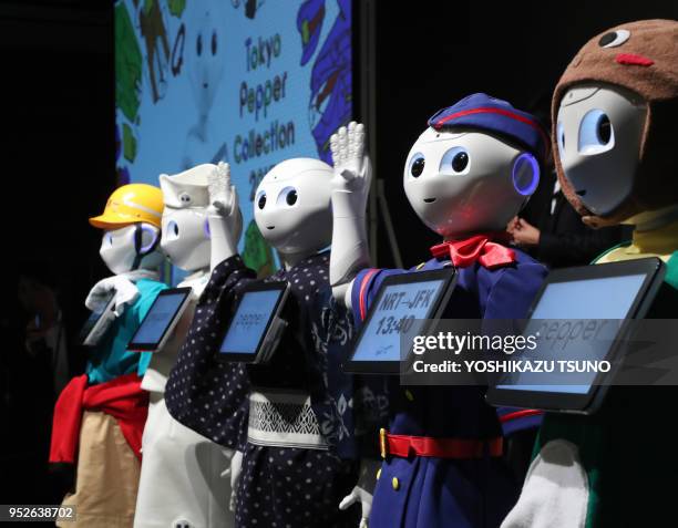 Softbank's humanoid robot Pepper display their outfits at Pepper's uniform design contest "Tokyo Pepper Collection" at the Pepper World exhibition in...