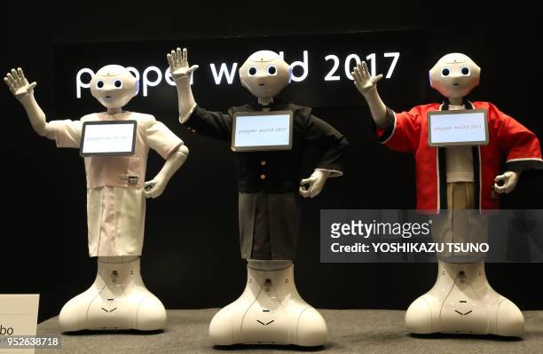 Softbank's humanoid robot Pepper display their outfits at Pepper's uniform design contest "Tokyo Pepper Collection" at the Pepper World exhibition in...