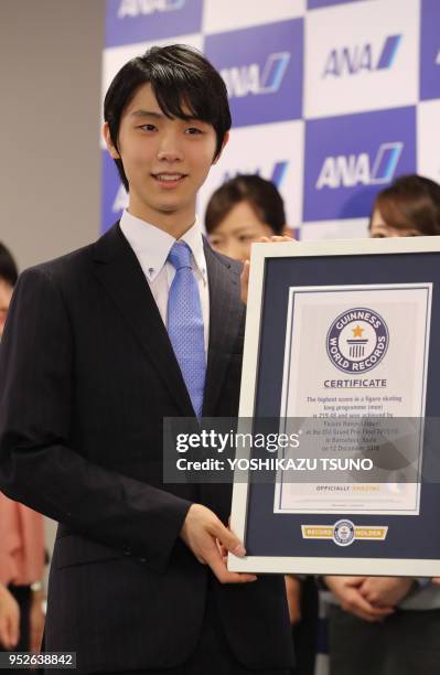 Olympic figure skating gold medalist Yuzuru Hanyu displays certification papers of Guinness World Record at All Nippon Airways headquarters on August...