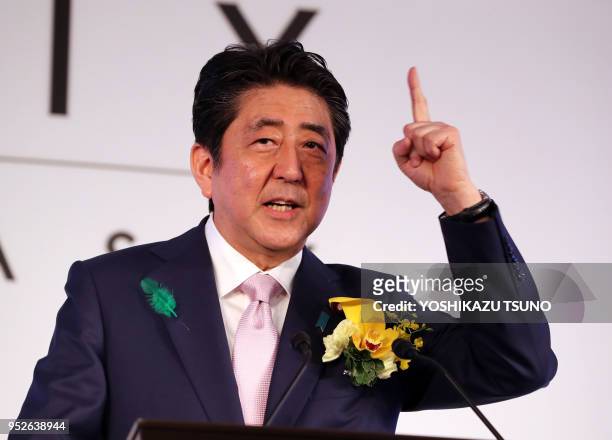 Japanese Prime Minister Shinzo Abe delivers a speech at the opening ceremony of Tokyo's new landmark Ginza Six in Tokyo's Ginza fashion district on...