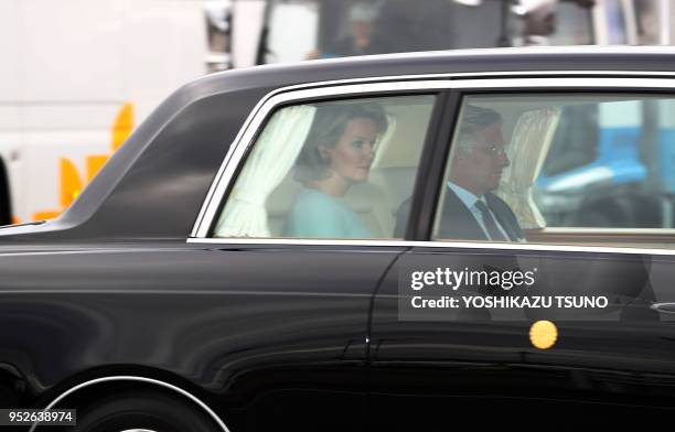 Belgian King Philippe and Queen Mathilde are in an Imperial limousine upon their arrival at the Tokyo International Airport on October 10, 2016....