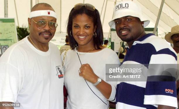 Roger E. Mosley, Laila Ali and husband Johnny "Yahya" McClain cE6 of Absollot Boxing inside the luncheon text at the Bob Beamon Golf and Tennis...