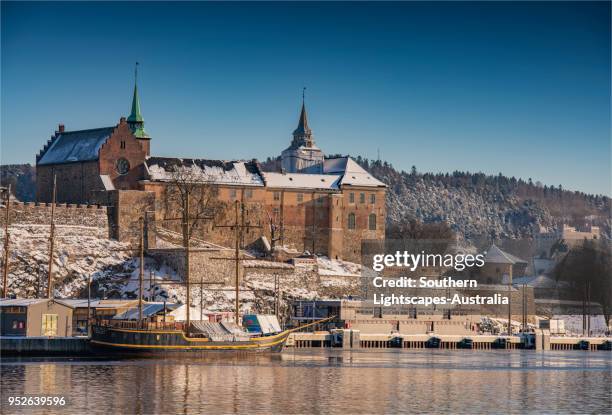 view to the akershus festning during mid-winter in oslo, norway. - akershus fortress stock-fotos und bilder