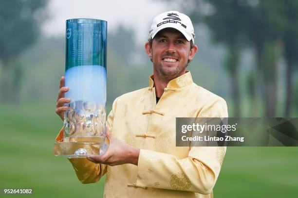 Alexander Bjork of Sweden holds the trophy celebrates after winning the 2018 Volvo China Open at Topwin Golf and Country Club on April 29, 2018 in...