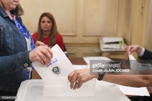 Woman casts her ballot voting for the Lebanon's parliamentary election on April 29 at the Lebanon consulate in Paris. - The Middle Eastern country...