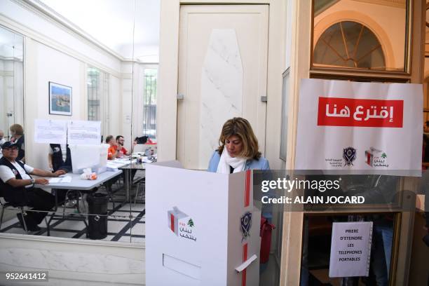 Woman prepares her ballot to vote for the Lebanon's parliamentary election on April 29 at the Lebanon consulate in Paris. - The Middle Eastern...