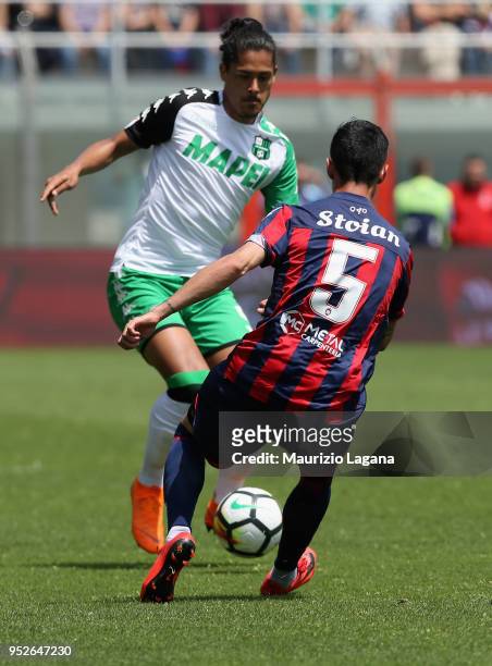 Adrian Stoian of Crotone competes for the ball with Mauricio Lemos of Sassuolo during the serie A match between FC Crotone and US Sassuolo at Stadio...