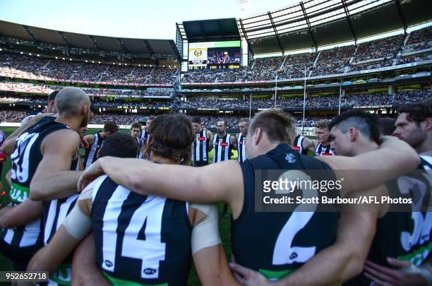 The Magpies form a team huddle during the 2018 AFL round six match between the Collingwood Magpies and the Richmond Tigers at the Melbourne Cricket...