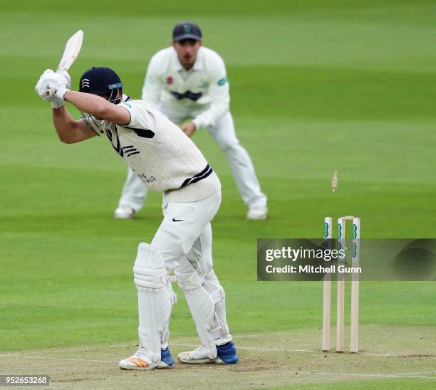 Hilton Cartwright of Middlesex is bowled out by Michael Hogan of Glamorgan during day three of the Specsavers County Championship Division Two match...