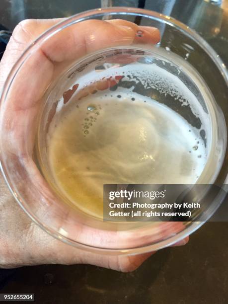 about to finish drinking a glass of cold beer - pale ale stock pictures, royalty-free photos & images