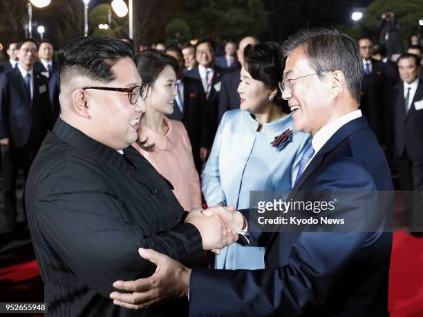 South Korean President Moon Jae In and North Korean leader Kim Jong Un, alongside their wives Kim Jung Sook and Ri Sol Ju, bid farewell in the border...
