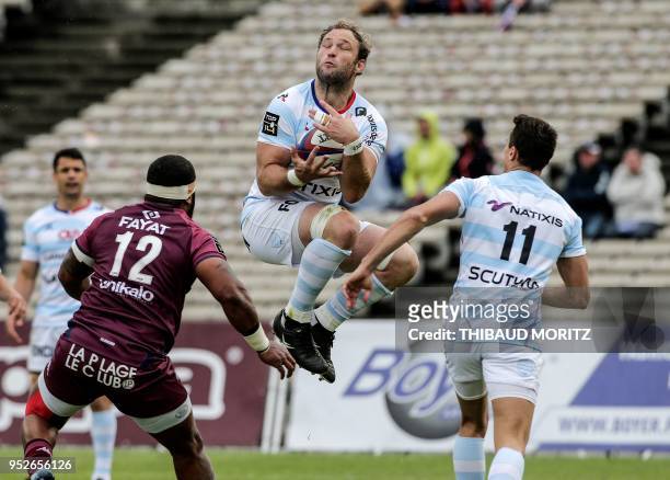 Racing 92's number eight Antonie Claassen catches a high ball as teammate Argentinian winger Juan Imhoff and Bordeaux-Begles Fijian centre Apisai...