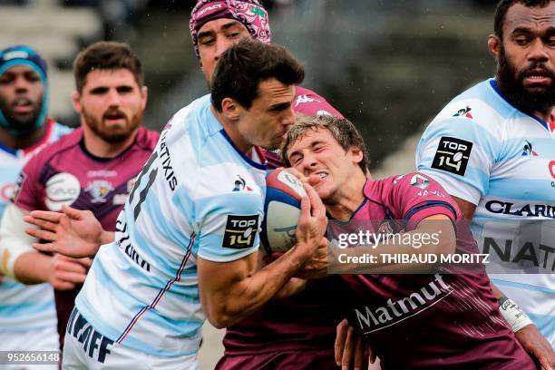 Bordeaux-Begles scrum-half Baptiste Serin tries to rip the ball from Racing 92's Argentinian winger Juan Imhoff during the French Top 14 rugby union...