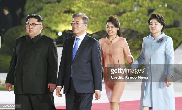 North Korean leader Kim Jong Un, South Korean President Moon Jae In, Kim's wife Ri Sol Ju and Moon's wife Kim Jung Sook walk to the venue of a...