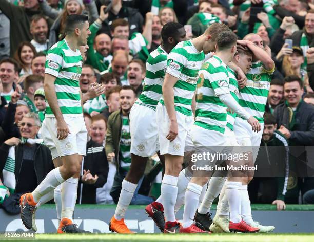 James Forrest of Celtic celebrates after scoring his sides third goal with his Celtic team mates during the Scottish Premier League match between...