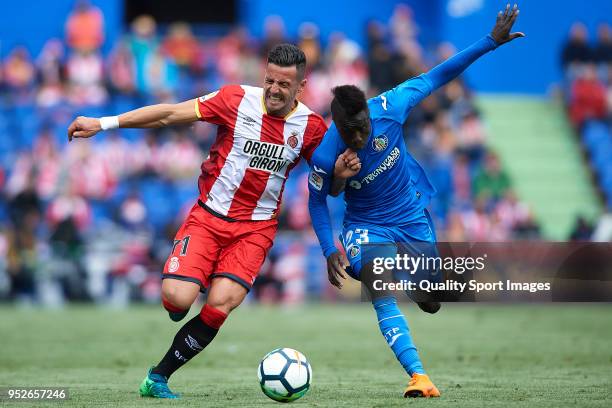 Amath Ndiaye of Getafe competes for the ball with Aday Benitez of Girona during the La Liga match between Getafe and Girona at Coliseum Alfonso Perez...