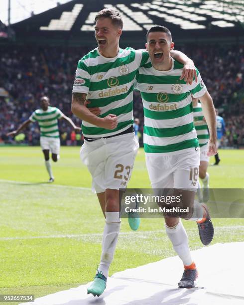 Tomas Rogic of Celtic celebrates after scoring his sides fourth goal with Mikael Lustig of Celtic during the Scottish Premier League match between...