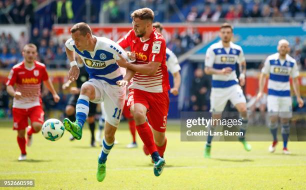 Stanislav Iljutcenko of Duisburg is challenged by Benedikt Gimber of Regensburg during the Second Bundesliga match between MSV Duisburg and SSV Jahn...