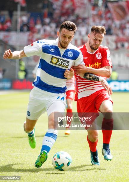 Boris Tashchy of Duisburg is challenged by Benedikt Gimber of Regensburg during the Second Bundesliga match between MSV Duisburg and SSV Jahn...