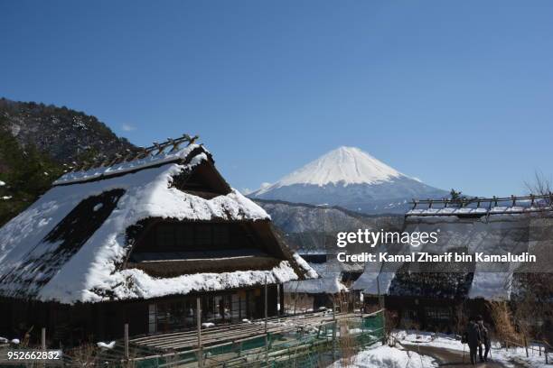 mt fuji and traditional houses - kamal zharif stockfoto's en -beelden