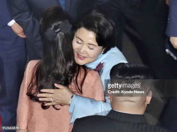 Kim Jung Sook , wife of South Korean President Moon Jae In, hugs Ri Sol Ju, wife of North Korean leader Kim Jong Un, at the end of her trip to the...