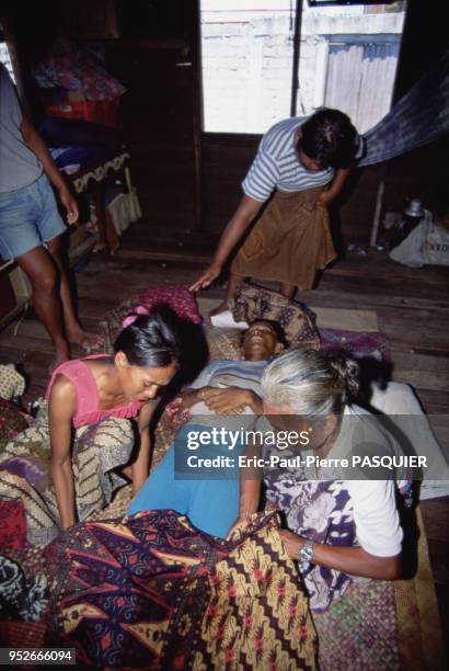 Pirates of the South China Sea And Philippines. Women assisting a pirate after a rough encounter at sea. On November, 2004.