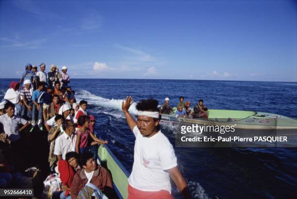 Pirates of the South China Sea And Philippines. A gang of pirates comes level with a boatload full of defenceless victims. On November, 2004.