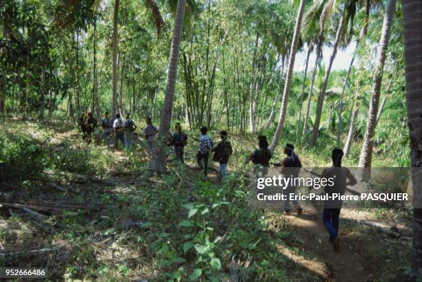 Pirates of the South China Sea And Philippines. This pirate gang heads out on patrol through the lush jungle of their island home. On November, 2004.