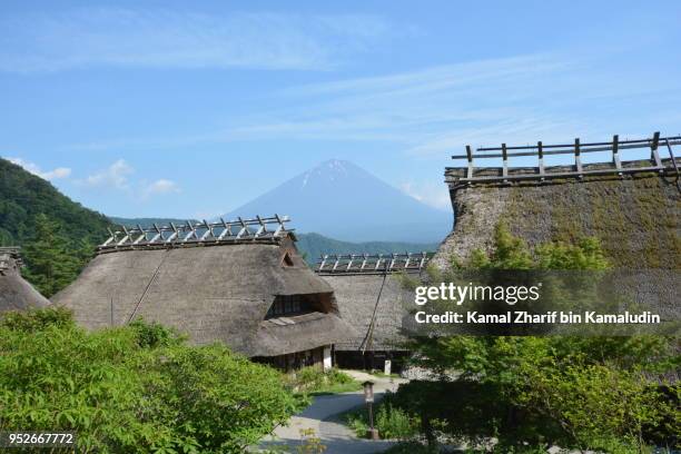 mt fuji and traditional houses - kamal zharif stockfoto's en -beelden