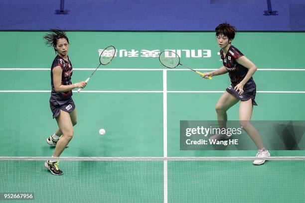 Yuki Fukushima and Sayaka Hirota of Japan hits a return during women's doubles final match against Misaki Matsutomo and Ayaka Takahashi of Japan at...
