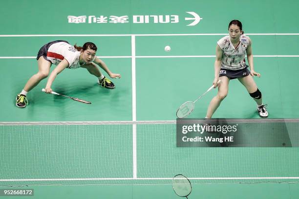 Misaki Matsutomo and Ayaka Takahashi of Japan hits a return during women's doubles final match against Yuki Fukushima and Sayaka Hirota of Japan at...