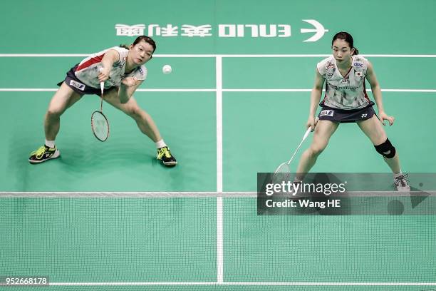 Misaki Matsutomo and Ayaka Takahashi of Japan hits a return during women's doubles final match against Yuki Fukushima and Sayaka Hirota of Japan at...